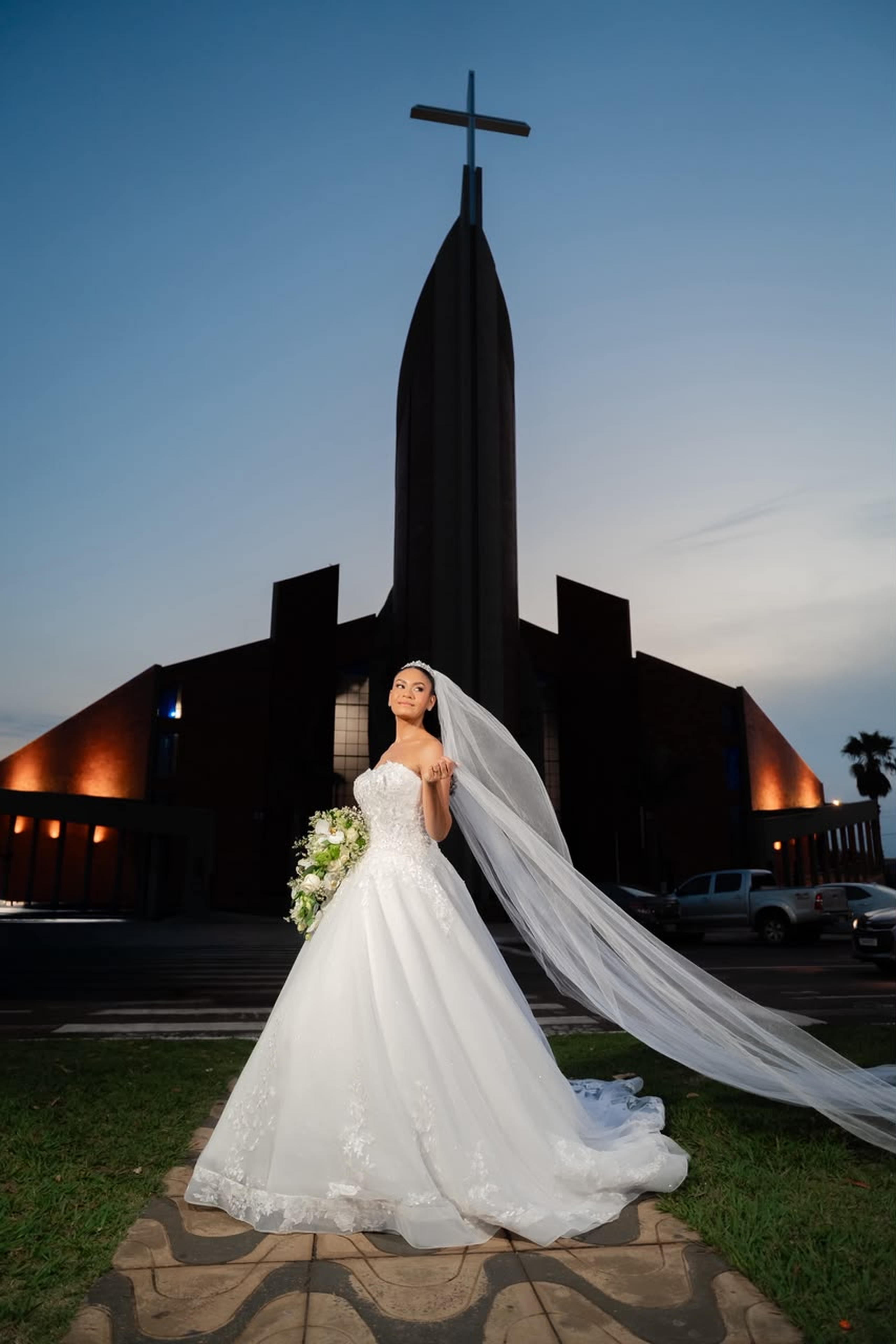 Noiva diante da igreja ao entardecer